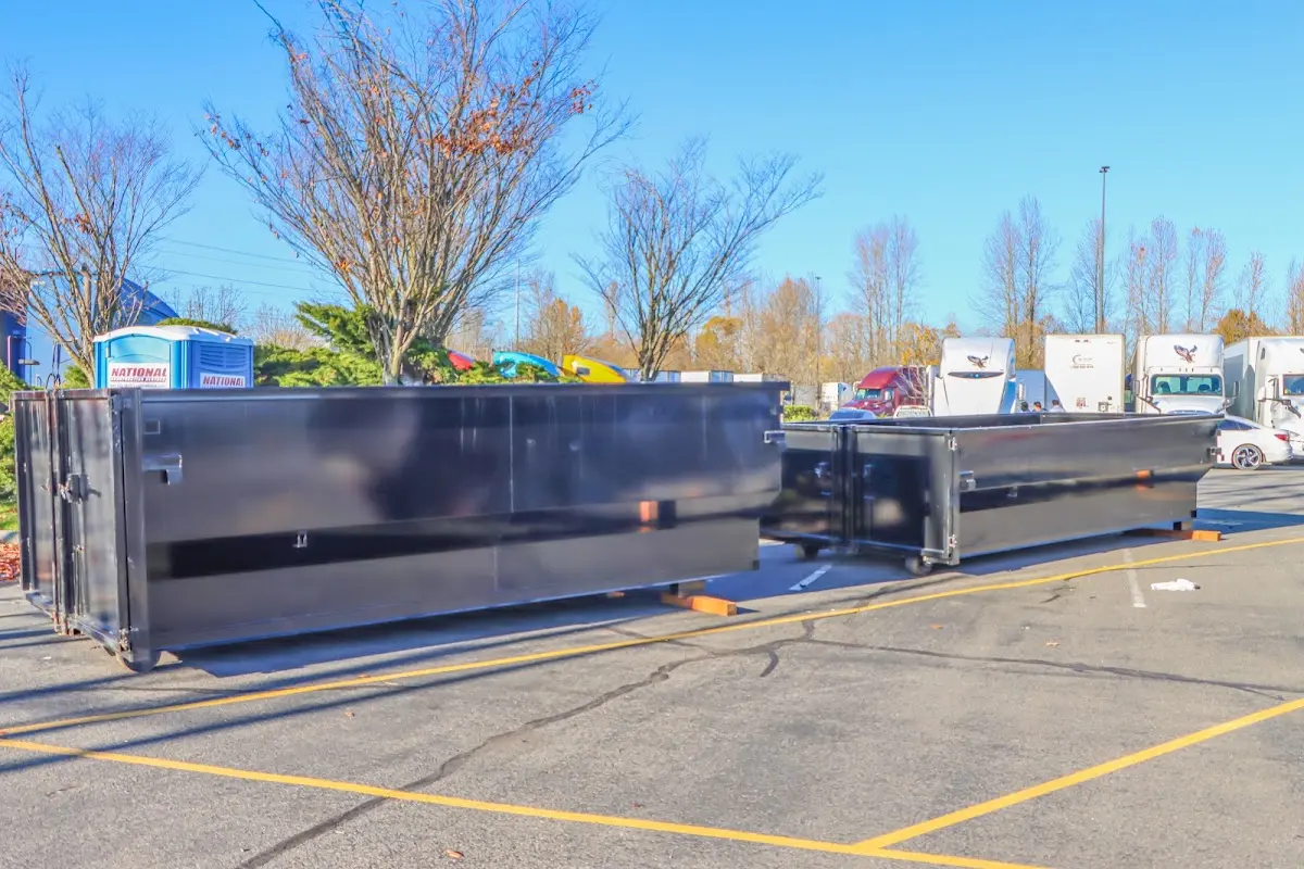 Professional dumpster rental service with roll-off container on residential driveway in Treasure Island